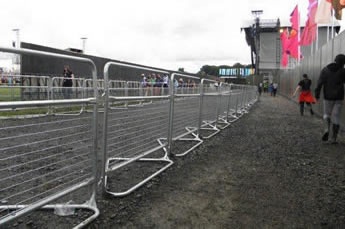 Woven police barriers are installed on the walkway.