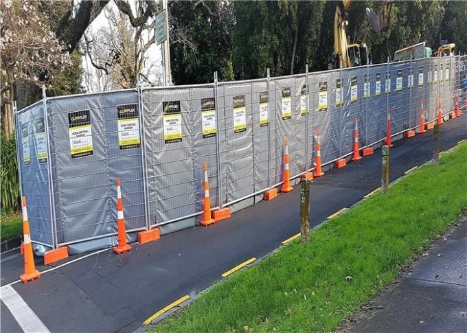 Sound barrier with temporary fence panel in construction site