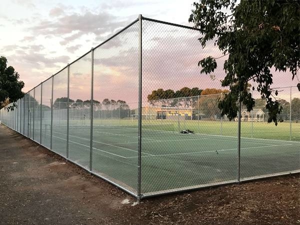Stainless steel chain link fences are installed surrounding the tennis court.
