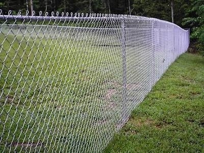 Galvanized chain link fence with knuckle selvage used in park.