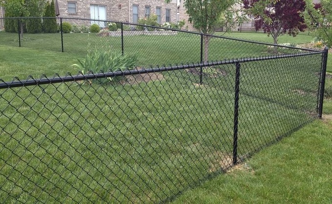 4 ft. tall black polymer-coated chain link fence around a house.