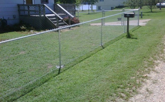 Standard galvanized chain link fence with swing gate.