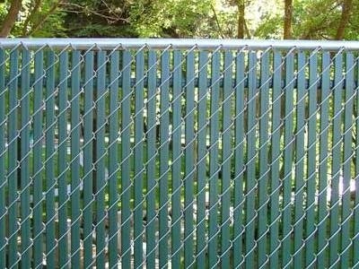 Green double wall top locking slats for yard fencing.