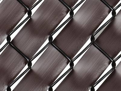 Brown fence weave inserted in black chain link fence.